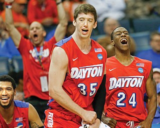 Dayton’s Jordan Sibert (24) and Matt Kavanaugh (35) celebrate during their NCAA Sweet 16 game against Stanford on Thursday in Memphis, Tenn. The Flyers continued their Cinderella run by downing the Cardinal, 82-72, and reaching the Elite 8 for the first time since 1984.