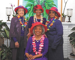 SPECIAL TO THE VINDICATOR
String of Pearls members of the Red Hat Society are preparing for its eighth annual luncheon April 9. Seated is Betty Crafter, royal queen mother; and standing, from left, are Carol Donnelly, founding queen; Erma Hart, reservations chairwoman; and Catherine Leftwich, vice queen.