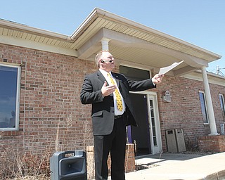 Narry Baker, an auctioneer, solicits bids for the former Jump Stretch Fitness Center on North Meridian Road. The Western Reserve Port Authority purchased the property Tuesday for $250,000 and plans to lease it to Mahoning County for a new dog pound.