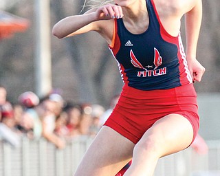 Fitch’s Jayme Ritchie clears a hurdle on her way to a first-place finish in the 300-meter event during Tuesday’s All-American Conference track meet Tuesday at Fitch High School in Austintown. Ritchie finished with a time of 47.7 seconds, and the Falcons girls won the meet.