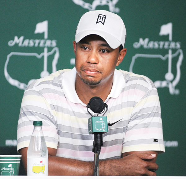 Tiger Woods listens at a news conference for the 2010 Masters in Augusta, Ga. Woods will miss the event for the first time after having surgery Monday for a pinched nerve in his back.