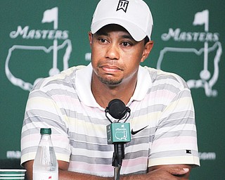 Tiger Woods listens at a news conference for the 2010 Masters in Augusta, Ga. Woods will miss the event for the first time after having surgery Monday for a pinched nerve in his back.