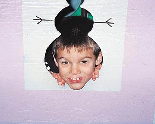 Nick Cavoulas of Canfield is poking his head through the hole in the wall. Sent by Paula Cavoulas.