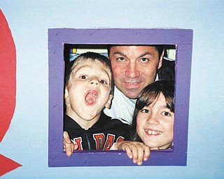 Zoe, Nick and Anthony Cavoulas, all of Canfield, put their heads together to make a cute family photo. Submitted by Paula Cavoulas.