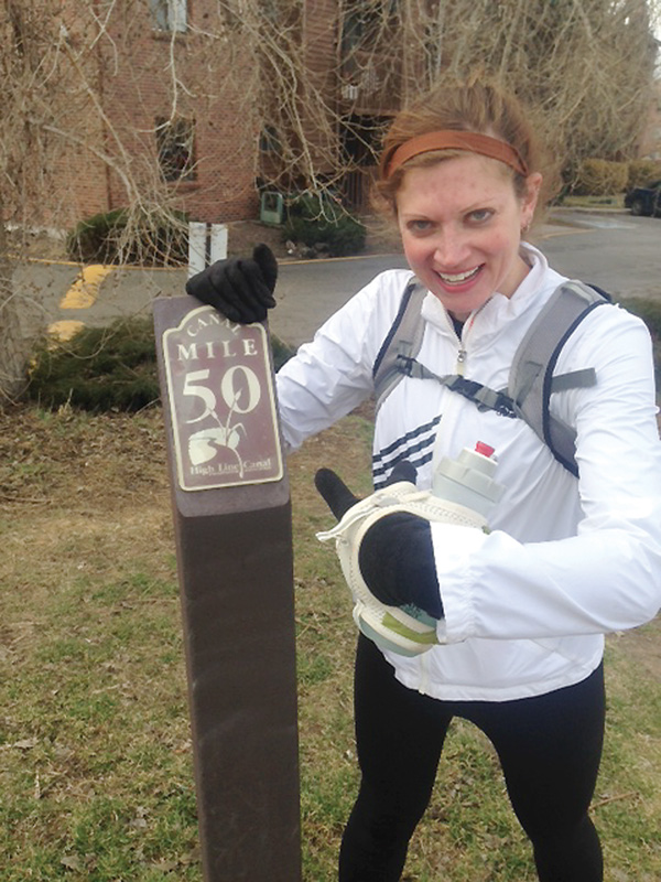 Cardinal Mooney High graduate Val Zajac poses next to the 50-mile sign on the High Line Canal trail last month
in Denver. Zajac ultimately ran 63 miles that day on a training run with her friends.