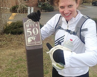Cardinal Mooney High graduate Val Zajac poses next to the 50-mile sign on the High Line Canal trail last month
in Denver. Zajac ultimately ran 63 miles that day on a training run with her friends.