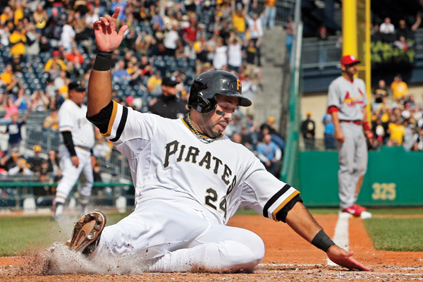 Pirates baserunner Pedro Alvarez scores on a double by Tony Sanchez off Cardinals starting pitcher Adam Wainwright during the seventh inning of Sunday’s game at PNC Park in Pittsburgh. The Pirates won 2-1.