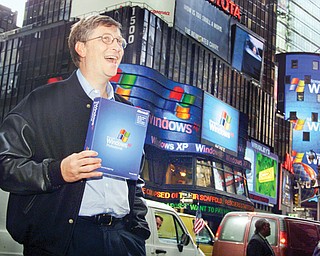 Microsoft chairman Bill Gates stands in New York’s Times Square to promote the new Windows XP operating
system. Microsoft will end support today for its still popular Windows XP. With an estimated 30 percent of
businesses and consumers still using the 12-year-old operating system, the move could put everything from
the data of major financial institutions to the identities of everyday people in danger if they don’t find a way
to upgrade soon.
