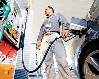 Eric Henry gases up his car in Sacramento, Calif. Drivers will get the slightest of breaks on gasoline prices this summer, according to the Energy Department. The national average price is forecast to fall — by just 1 cent — to $3.57 per gallon between April and September, the months when Americans do most of their driving.