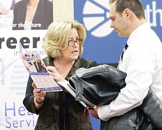 Recruiter Valera Kulow, left, speaks with job-seeker Leonardo Vitiello during a career fair in Dallas. The Labor Department said Tuesday that employers advertised 4.2 million job openings in February, up 7.7 percent from January.