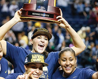 Connecticut players celebrate with the championship trophy after defeating Notre Dame in the NCAA women’s
basketball tournament championship Tuesday in Nashville, Tenn. Connecticut won 79-58.