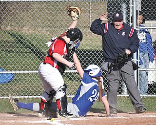 Poland baserunner Chloe Bush is tagged out at home by Fitch catcher Alex Coe during their softball game Wednesday in Austintown. The Bulldogs blanked the Falcons, 3-0.