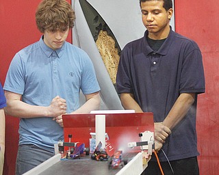 Patrick Riley, left, and Justyn Williams go head-to-head with their carbon-dioxide cars at Chaney High School. The boys, both juniors in the Science, Technology, Engineering and Mathematics program, built the cars. Then, 
finishing with the best times of their classmates Thursday, they raced each other. Williams won in the best-of-three final.