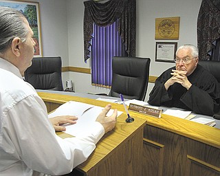 Canfield Mayor Bernie Kosar Sr. conducts mayor’s court earlier this week. A defendant discusses his case with Kosar.