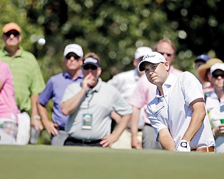 Bill Haas watches his chip shot onto the 17th green of Augusta National Golf Course in Augusta, Ga., on Thursday during Round 1 of The Masters. Haas shot a 68 to finish with a one-stroke lead.