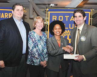 SPECIAL TO THE VINDICATOR
At the March 19 meeting of the Rotary Club of Warren, President John Campolito presented a check for $10,000 to Kenya Roberts-Howard, YWCA executive director, and Shari Harrell, past YWCA executive director. The check is the final installment of a pledge made three years ago toward the YWCA’s building/renovation drive. Harrell secured the $30,000 pledge from the Rotary Club of Warren in 2012. The pledge helped to fund construction of a project that will provide safe housing for women in transition. Harrell is the president and CEO of the Community Foundation of the Mahoning Valley. From left to right are Nick Odille, past president of Rotary of Warren; Harrell; Roberts-Howard; and Campolito.