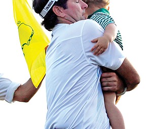 An emotional Bubba Watson carries his son Caleb after holding off Jordan Spieth and Jonas Blixt to win the
Masters on Sunday at Augusta National Golf Course in Augusta, Ga. It was the second green jacket for Watson,
who won the tournament three years ago.