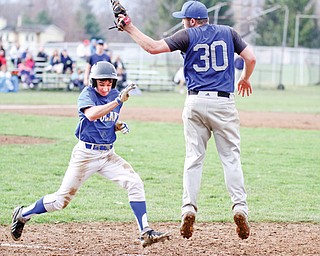 Poland’s Chase Knodle, left, is about to be tagged out at first by Lakeview’s Anthony Senter (30) during Monday’s action in Cortland.