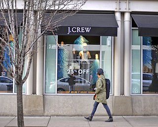 In this March 24 photo, a pedestrian passes a J.Crew store in the Shadyside shopping district of Pittsburgh. The Commerce Department reported Monday that U.S. retail sales in March rose 1.1 percent, the largest amount in 18 months.