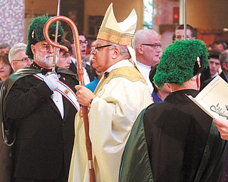 Bishop George V. Murry of the Catholic Diocese of Youngstown follows priests into St. Columba Cathedral in Youngstown, where the Chrism Mass took place Tuesday morning. Knights of Columbus members form an entrance for the bishop. At the special Mass, the bishop blessed oils and consecrated chrism, a sacred oil.