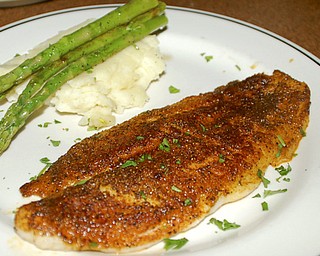 Blackened grouper served with mashed potatoes and asparagus.