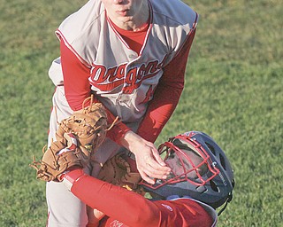 Niles catcher Carson Cameron and third baseman Jaret Johnson collide while trying to field a foul ball during their game Wednesday against Howland at Eastwood Field in Niles. The Tigers shut out the Red Dragons, 7-0.