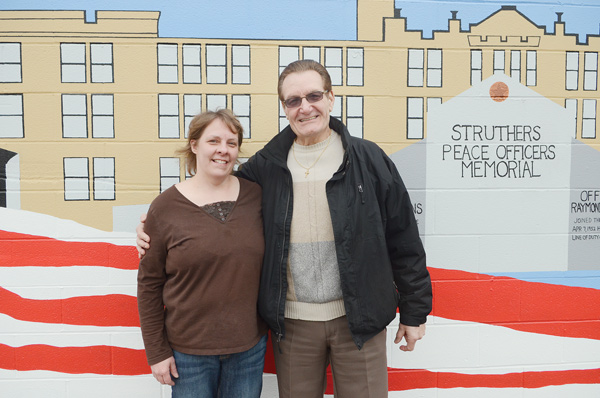 Melanie Rauschenbach, president of the 1st Ward Block Watch, and Councilman Tony Fire stand in front of the mural on South Bridge Street. The two are planning a fundraiser for Struthers upgrades.