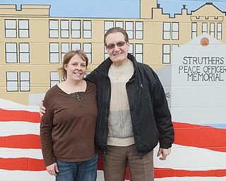 Melanie Rauschenbach, president of the 1st Ward Block Watch, and Councilman Tony Fire stand in front of the mural on South Bridge Street. The two are planning a fundraiser for Struthers upgrades.