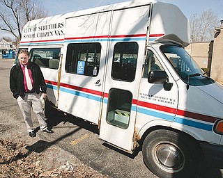 Mayor Terry Stocker stands beside the city’s senior van, which has been out of service for more than a month. Deemed not roadworthy, the 1997 Dodge van was the sole means of transportation for many of its passengers. The city is exploring options to quickly put a safe senior van back on the road.