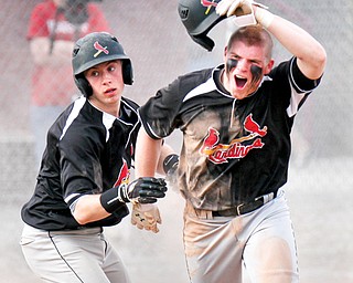 Canfield’s Alec Buchenic, right, celebrates with teammate Carter Rhoads after scoring against Fitch during their game in Austintown. The Cardinals edged the Falcons, 4-3.