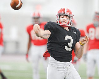 Junior quarterback Dante Nania throws a pass after scrambling out of the pocket during a spring practice at the WATTS. He’s one of four quarterbacks vying for the starting job.