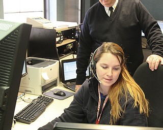 Boardman dispatcher Lauren Bruno with Fire Chief George Brown in the township’s dispatch room. The township recently switched to a new state-of-the art radio system. The dispatchers are now using the system for both the Boardman fire and police departments. Last year, Boardman and Austintown police departments joined forces to improve their radio systems and split the $1.5 million cost. Boardman’s share was was covered by seized money and grants, Police Chief Jack Nichols said.
