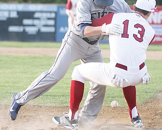 Shane Vitullo of Fitch collides with Cardinal Mooney first baseman Andrew Armstrong on the first play — and for the first out — of their baseball game Thursday at Cene Park in Struthers. The Cardinals dominated the Falcons, 12-2, in six innings.