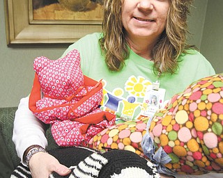 Kim Calhoun of Hospice House holds donated items that will be given to children 
attending Grief Camp in June. William D. Lewis | The Vindicator








William D. Lewis | The Vindicator 
