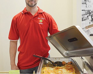 Carlos Ramirez of Casa Ramirez Mexican restaurant in Youngstown shows off a chicken dish called pollo michoacano at the Memorable Meals Mahoning Valley. More than 350 attended the event.