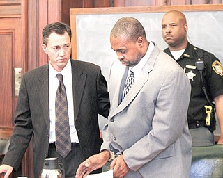 Willie Wilks leaves the Mahoning County Common Pleas courtroom after a jury recommended a death sentence for him Monday. With him is his attorney, Ron Yarwood. Yarwood had no comment on the verdict.