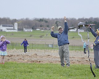 Katie Rickman | The Vindicator.Carissa Byler, 8, of Canfield flies her kite with the help of her father Gene and her brother Matthew, 13, at the Kite Festival at the Mill Creek MetroParks Farm in Canfield May 3, 2014.