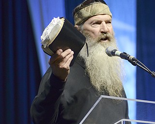 Katie Rickman | The Vindicator.Duck Dynasty's Phil Robertson holds up his Bible while speaking to an estimated crowd of 4,500-5,000 men at Youngstown's Rally in the Valley at the Covelli Centre May 6, 2014.