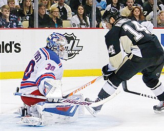 With Pittsburgh Penguins’ Chris Kunitz (14) getting an assist, New York Rangers goalie Henrik Lundqvist (30) can’t stop a shot from the point by the Penguins’ Kris Letang, not shown, in the second period of game 2 of a second-round NHL playoff series in Pittsburgh on Sunday.