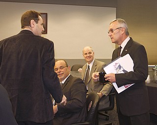 YSU presidential candidate and former coach Jim Tressel greets Dean Martin Abraham at YSU this morning as he meets with deans, faculty, and the executive team before a 2 p.m. forum at the university.Behind them are Deans Joesph Mosca and Bryan DePoy 