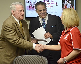 John Kopp presents Nancy Knight with a check during an award ceremony for two local students who won the John Kopp Hear of a Champion Award May 7, 2014.