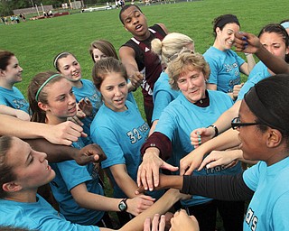 Boardman girls track coach Denise Gorski, center, is surrounded by her team Monday after the Spartans
surprised their coach for her retirement with a flash mob to her favorite song — ABBA’s “Dancing Queen” —
at their final home meet at the Boardman High track. The girls also wore bright blue T-shirts that read: “32 years
of Gorski’s tradition” on the front, and “It ends with us” on the back.