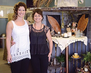 Meagan Albani, 31, left, poses with her mother, 51-year-old Elizabeth Albani, in their shop, 2 Bisous Studio, in downtown Struthers. The studio, which opened Saturday, off ers upcycled, or repurposed, European vintage pieces as well as language classes.
