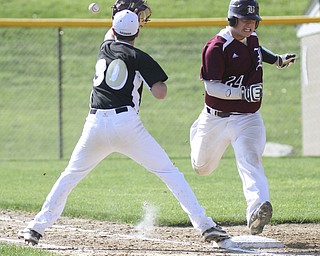 William D.Lewis The Vindicator  Boardman's Lou Cardona(24) is safe at first as Warren's Marcus Masters(30) waits for the throw during 5-13-2014 action at Boardman.
