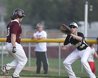 William D.Lewis The Vindicator  Boardman's Evan Croutch(33) is safe at first as Warren's Marcus Masters(30) waits for the throw during a pick off attempt 5-13-2014 action at Boardman.