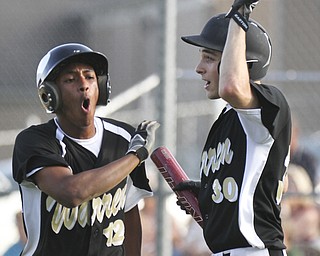 William D.Lewis The Vindicator  Warren's Adam Butler(12) reacts afer scoring during 7th inning at right is Marcus Masters(30) Warren won 3-2 after going ahead in the 7th during 5-13-2014 action at Boardman.