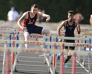CANFIELD, OHIO - MAY 13, 2014: Sam Ortz of Fitch sprints to the finish line ahead of Ladwan Hester of East during the boys 110 meter hurdles during the AAC Red Tier Division track meet at Canfield High School. (Photo by David Dermer/Youngstown Vindicator)