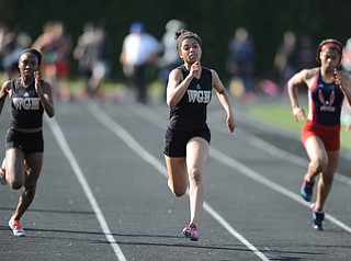 CANFIELD, OHIO - MAY 13, 2014: Justice Richardson of Harding sprints to the finish line ahead of Chyna Stroud of Harding and Brittany Floyd of Fitch during the girls 100 meter dash during the AAC Red Tier Division track meet at Canfield High School. (Photo by David Dermer/Youngstown Vindicator)