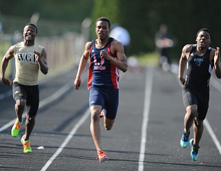 CANFIELD, OHIO - MAY 13, 2014: Joe Harrington of Fitch sprints to the finish line ahead of Elijah Cofield of Harding and Dezmeon Allen of East during the boys 100 meter dash during the AAC Red Tier Division track meet at Canfield High School. (Photo by David Dermer/Youngstown Vindicator)