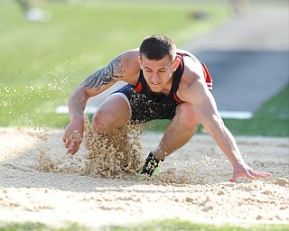 CANFIELD, OHIO - MAY 13, 2014: Sam Ortz of Fitchs plants himself in the sand after landing during the boys long jump during the AAC Red Tier  Division track meet at Canfield High School. (Photo by David Dermer/Youngstown Vindicator)